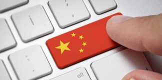 Finger pressing keyboard key with China flag design
