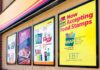 Store window posters advertising SNAP EBT acceptance and product deals