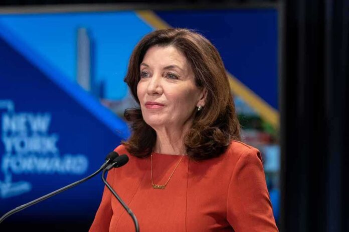 woman speaking at a podium with microphones