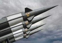 Four military missiles with radiation symbols pointed skyward