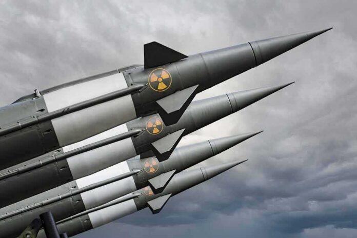 Four military missiles with radiation symbols pointed skyward