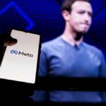 Kids Hooked? Jury Probes Meta Playbook smartphone showing Meta logo in front of a blurred speaker on stage