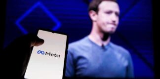 smartphone showing Meta logo in front of a blurred speaker on stage