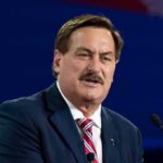 Man in suit speaking at a podium