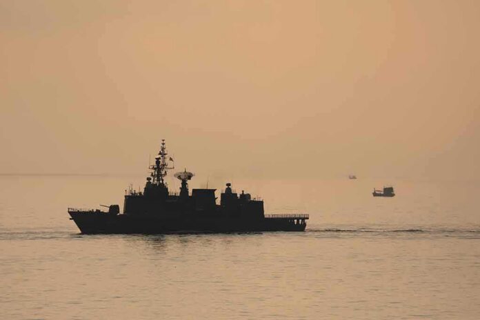 naval ship silhouette at sea during sunset