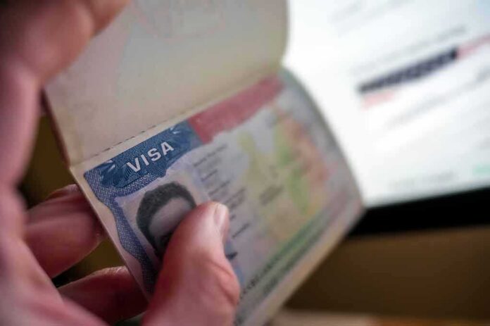 Hand holding a passport with a visa page