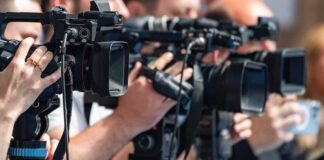 television cameras on tripods at a media event