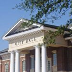 Trump Allies Push Citizenship Debate Further Exterior view of a city hall building with columns and a clear blue sky