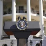 Presidential podium with seal in front of white-columned building