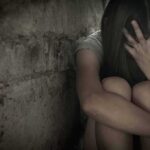 Hidden Pattern Exposed: Partners, Not Strangers Person sitting against a rough wall with head in hand