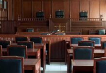 Empty courtroom with wooden benches and judge's bench