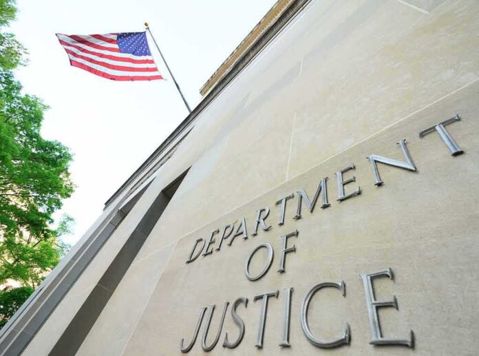shutterstock_1384089731-1 Department of Justice building with American flag