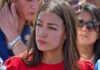 woman in red top at an outdoor event