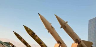 Row of surface-to-surface missiles mounted on display stands outdoors