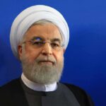 Trump Says Progress, Tehran Says Not Yet Hassan Rouhani portrait against a blue background