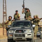 U.S. Lawmaker’s West Bank Trip Turns Dangerous armed men riding on pickup trucks in a convoy