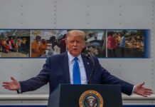 Media Showdown Spurs ‘Trump TV’ Blitz Donald Trump speaks at a podium with arms outstretched