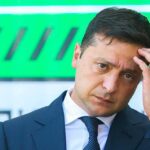 Kyiv’s Intelligence Feud Suddenly Turns Violent man in a suit touching his head