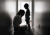 Silhouettes of adult and child in hallway