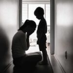 Awareness Or Sales Pitch? Moms Caught Between Silhouettes of adult and child in hallway