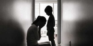 Silhouettes of adult and child in hallway