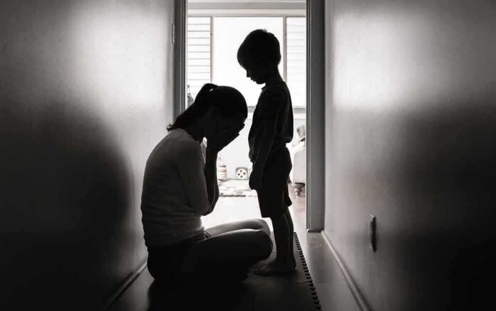 Silhouettes of adult and child in hallway