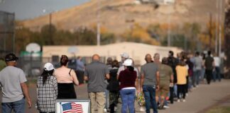 voters standing in a long line outside a polling place