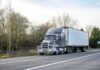 Semi-truck parked on roadside with trailer