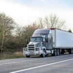 Semi-truck parked on roadside with trailer
