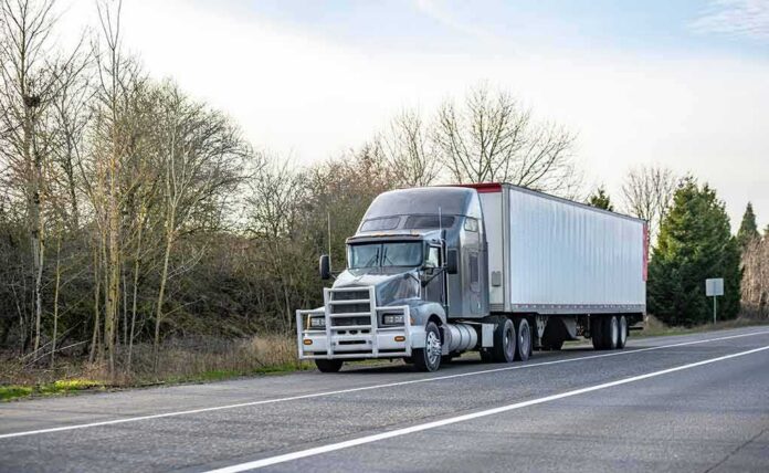 shutterstock_1924650818 Semi-truck parked on roadside with trailer