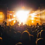 Did A Concert Mishap Spark A Viral Moment? Crowd at a nighttime concert with bright stage lights