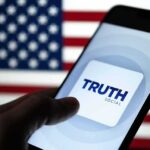 Smartphone displaying Truth Social app against an American flag backdrop