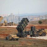 Unseen Threat: Belarus and Russia’s Nuclear Playbook Patriot missile launchers deployed on a field near a city