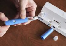Late-Life Boost: Ozempic Defies Aging Hands assembling a blue insulin pen with packaging on a table