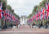 Union Jack flags line a broad avenue with mounted guards