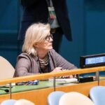 Hidden Agenda? Qatar’s Double Role in Gaza Crisis Woman seated at a United Nations desk with a United States nameplate