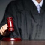 Self-Defense Win, Gun Ban Anyway Judge with gavel striking sound block