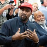 When Loyalty Outlasts Years of Public Controversy Kanye West speaking while Jim Brown sits nearby in a crowded room