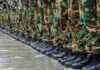 Row of soldiers in camouflage pants and black boots
