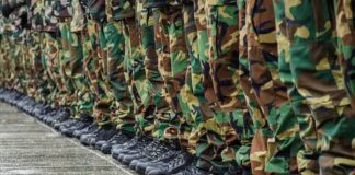 Row of soldiers in camouflage pants and black boots