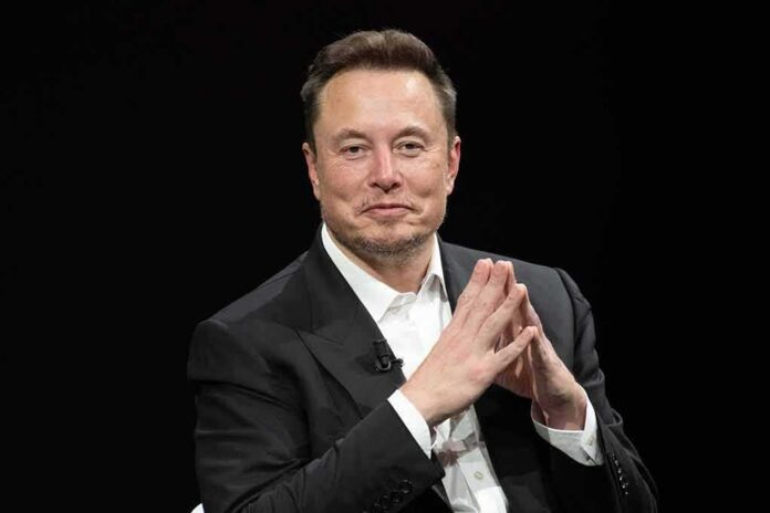 Man in a dark suit with hands clasped together