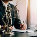 A Major Abortion Guardrail Just Vanished Lady Justice statue on a lawyer’s desk