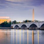 Arrests Fuel Fight Over Memorial Damage Arlington Memorial Bridge with monuments at dusk