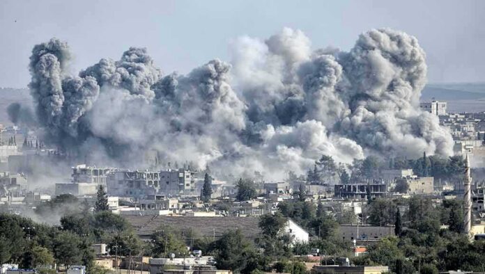 shutterstock_325363238 Massive smoke plumes rise over a city after explosions