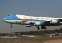 Airplane with blue and white livery landing approach