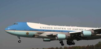 Airplane with blue and white livery landing approach
