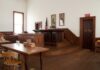 Florida Grand Jury Rocks Intelligence Old Guard Interior of a historic courtroom with wooden furniture and an American flag