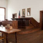 Florida Grand Jury Rocks Intelligence Old Guard Interior of a historic courtroom with wooden furniture and an American flag