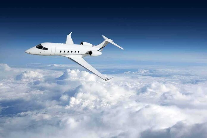Private jet flying above clouds