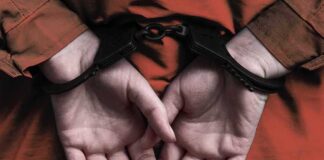 person in handcuffs with hands behind back